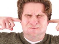 man-with-ears-plugged-eyes-closed-holding-breath.jpg